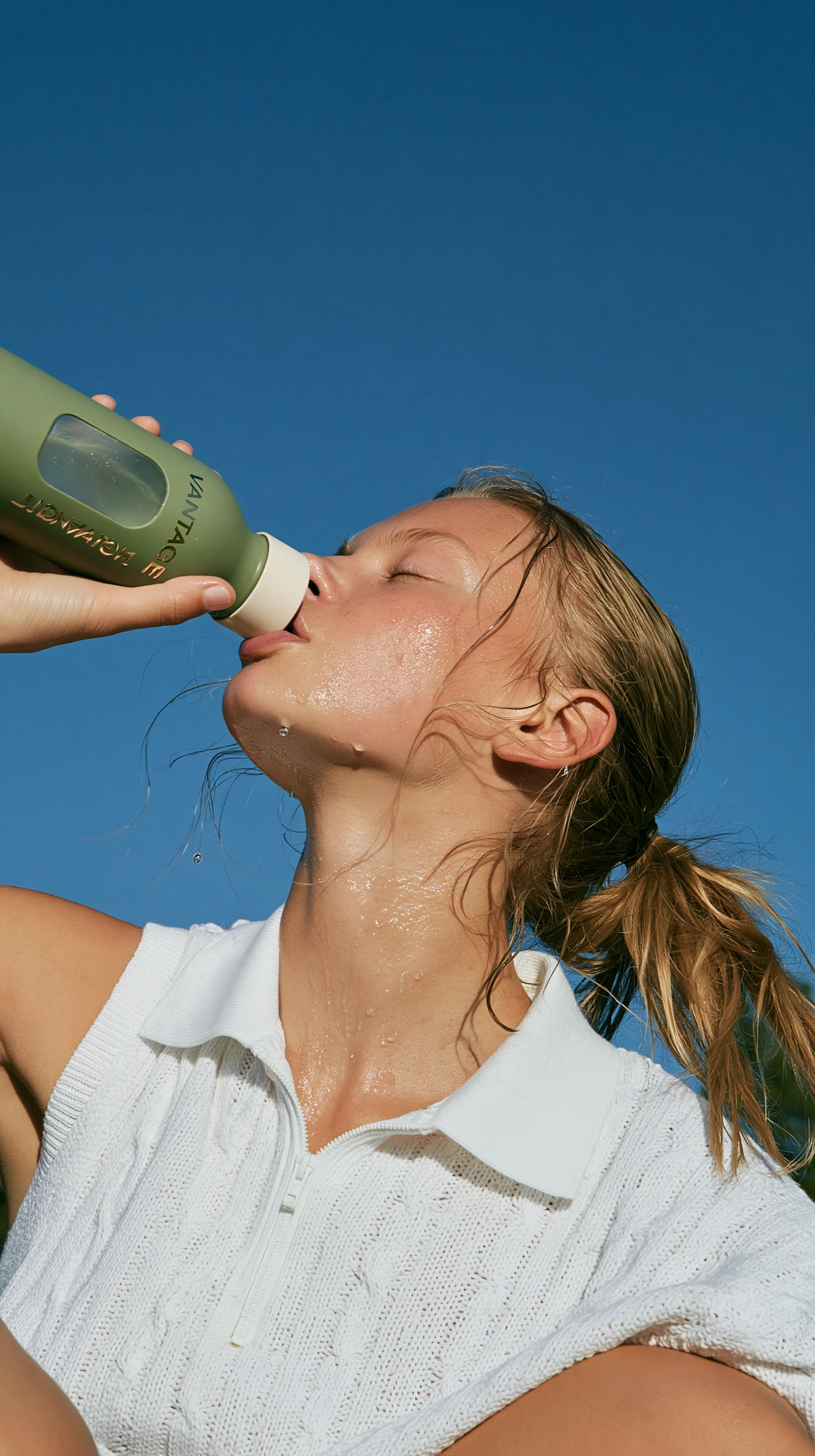 Woman drinking from a transparent bottle